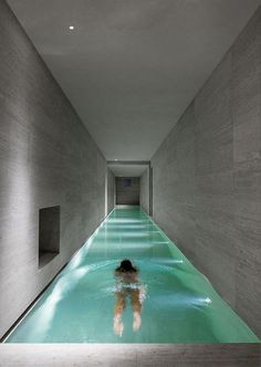 a person is swimming in a long pool