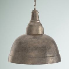 an industrial style pendant light hanging from a ceiling fixture with a chain attached to it