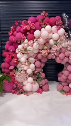 an arch made out of balloons and flowers