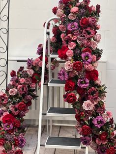 a bunch of flowers that are on some steps