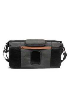 the grey and black dog carrier with brown leather trims on it's side