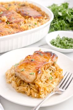 a plate with rice and meat next to a casserole dish on a table