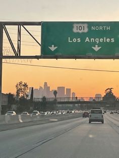 a freeway sign that reads 101 north and los angeles above the highway with traffic on both sides