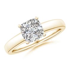 a yellow gold engagement ring with a cushion cut diamond