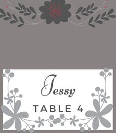 a table number card with flowers and leaves on the front, in grey and white