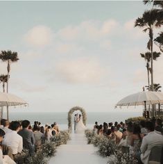 a wedding ceremony on the beach with an ocean view