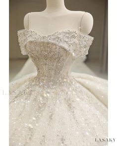 a white wedding dress with silver sequins on it