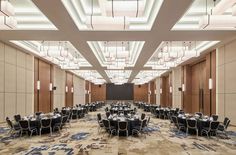 a large room with tables and chairs set up for a formal function in the center