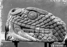 a large stone sculpture sitting on top of a wooden stand