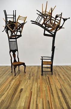 two wooden chairs sitting on top of a hard wood floor