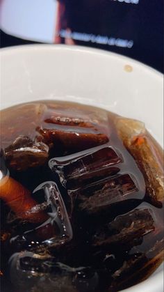 a white bowl filled with liquid and ice