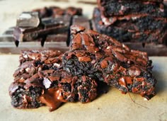 three pieces of chocolate brownie sitting on top of a table next to each other