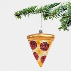 a slice of pizza ornament hanging from a christmas tree with pine cones on it