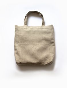 The Mitaka Linen Large Bag is the perfect bag to carry day to day. Made of 100% linen, this lightweight bag won’t add any extra burden on your shoulder. With its double layers of fabric, this bag has the ideal sizing and durability for your tablet, wallet, and office materials. The three pockets are great for organizing your supplies. An added bonus is that The Mitaka Linen Bag is reversible, so your inside pockets can be transformed into outside pockets with a quick tug and a flip! Reversibility for style and function. Made of double layers of 100% linen. Double sided clean-finish seams. 3 pockets. 16”H x 14-3/4”W x 3-1/4”D. 8-1/2” shoulder drop. Made in the USA. Care Instructions: Machine wash. Ironing as needed. Linen Tote Bag For Travel, Casual Linen Canvas Bag For Daily Use, Rectangular Natural Bag With Pockets, Neutral Cotton Bags For Daily Use, Neutral Rectangular Canvas Bag For Everyday Use, Rectangular Neutral Canvas Bag For Everyday Use, Everyday Use Neutral Rectangular Canvas Bag, Beige Linen Canvas Bag For Travel, Casual Rectangular Linen Canvas Bag