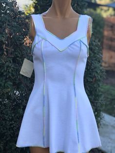 Here is a vintage 1970s polyester tennis dress. Made by Riha.New Old Stock with Hangtags.Size 8.Following are the measurements. Bust 32",waist 26",Hips 44",length measured from top shoulder to hem 29".Zips up the back. White polyester fabric. Different Pastel colors done in  zig zag on edges.In nice vintage condition. Please take special consideration of measurements. 1970s sizing was very small to today's standards. Tennis dresses were very short not like a regular dress. So please take special note of length. If you live overseas please email me first before purchasing for mailing cost. Price quoted is for USA only Retro Fit And Flare Mini Dress For Spring, Fitted Tennis Dress For Spring, Casual Fitted Spring Tennis Dress, Spring A-line Stretch Tennis Dress, Spring A-line Tennis Dress With Stretch, White V-neck Tennis Dress For Spring, Blue Spring Tennis Dress, Fitted Cotton Tennis Dress For Spring, Fitted V-neck Tennis Dress For Spring