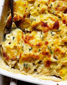 a casserole dish with chicken, cheese and herbs in it is ready to be eaten