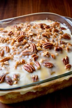 a glass baking dish filled with cream and pecans