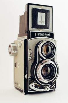 an old fashioned camera sitting on top of a table