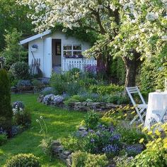 the garden is full of flowers and trees