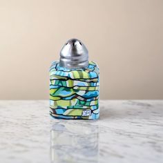 a small blue and green object sitting on top of a counter