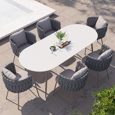 a white table with grey chairs around it