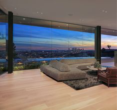 a living room filled with furniture and large windows