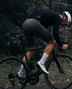 a man riding on the back of a bike down a road