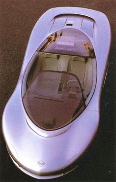 the futuristic car is parked on the pavement