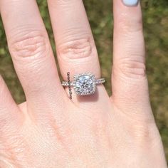 a woman's hand with a ring on it and a diamond in the middle