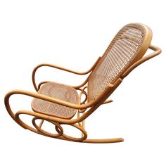 a wooden rocking chair with wicker seat and back support, on a white background