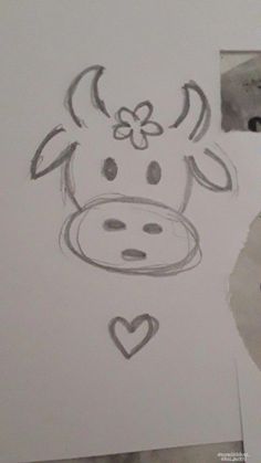 a drawing of a cow's head with hearts and a flower on its nose