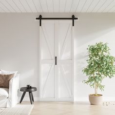 a living room with a couch, table and sliding barn door that opens to the outside