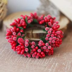 a close up of a wreath on a table with other items in the back ground