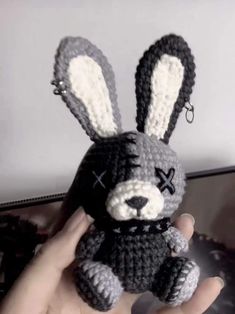 a crocheted stuffed animal in the shape of a bunny is being held by someone's hand