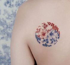 the back of a woman's shoulder with flowers painted on her left arm and chest