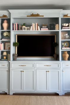 an entertainment center with built - in bookshelves and cabinets