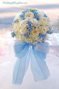 a bridal bouquet with blue and white flowers