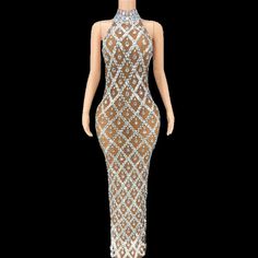 a mannequin wearing a dress with an open back and beading on it