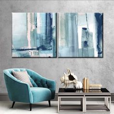 two paintings are hanging on the wall above a coffee table