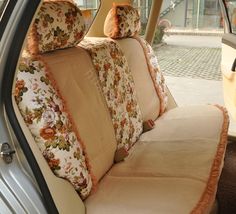 the interior of a car with floral cushions