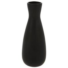 a black vase sitting on top of a white table