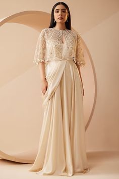 Off-White Modal Satin Draped Gown Saree With Jacket Design by ROQA at Pernia's Pop Up Shop 2024 Cape Top Outfits, Cape Dress Indian, Drape Sari, Saree Jacket Designs, Cape Dresses, Wedding Guess, Off White Saree, Cutdana Embroidery, Saree Gowns