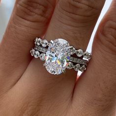 a woman's hand with a ring on it and a diamond in the middle