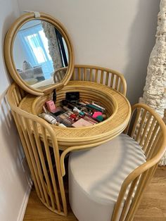 a round table with a mirror on it next to a chair