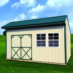 a small shed sitting in the middle of a green field