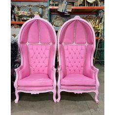 two pink chairs sitting next to each other