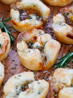 small appetizers with herbs and cheese on a wooden board