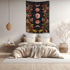 a large tapestry hanging on the wall above a bed