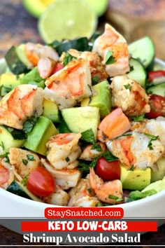 shrimp avocado salad in a white bowl with lime wedges on the side