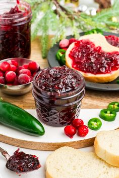 cranberry sauce in a jar surrounded by bread, peppers and other holiday foods